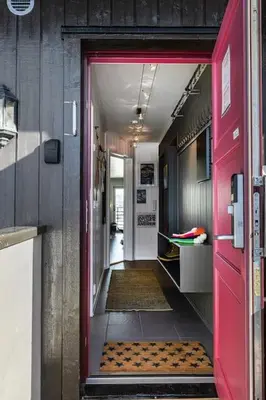 a red door leading into a room with a hallway at Skarsnuten Panorama 46 in Hemsedal