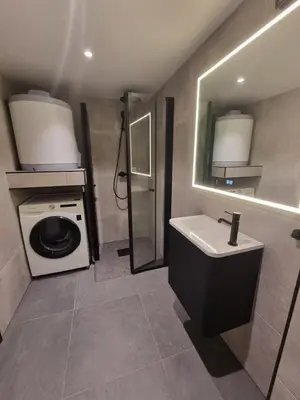 a bathroom with a washing machine and a sink at Near Bergen City, Apartment 7 min from the airport, free parking in Bergen