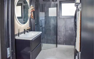 a bathroom with a sink and a shower and a mirror at 5 Bedroom Nice Home In Hemsedal in Hemsedal