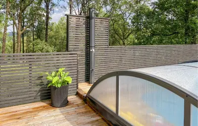 a wooden deck with a fence and a potted plant at Gorgeous Home In Skjold With Kitchen in Skjold