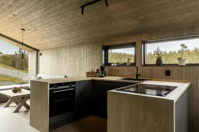 a kitchen with a sink and a counter top at Moderne hytte på Norefjell in Noresund