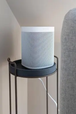 a speaker sitting on top of a chair at Dinbnb Apartments I Mid-City Luxury with Mini Balcony and Smart TV & Sound System in Bergen