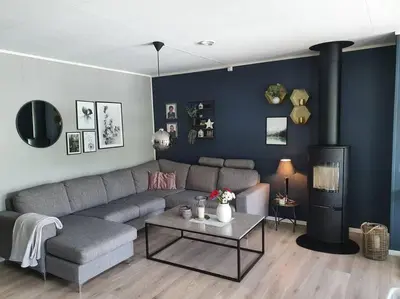 a living room with a couch and a table at Nydelig leilighet- Solrik/2 balkonger in Seim