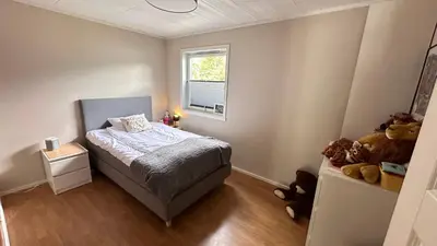 a small bedroom with a bed and a window at Panorama #CasaSolvik #Loen in Loen