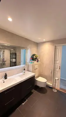 a bathroom with two sinks and a tub and a toilet at Panorama #CasaSolvik #Loen in Loen