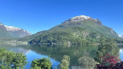 a view of a lake with mountains in the background at Panorama #CasaSolvik #Loen in Loen