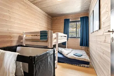 a bedroom with two bunk beds in a log cabin at Rindabakkane Lodge in Sogndal