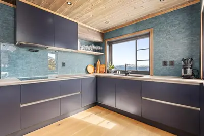 a kitchen with purple cabinets and a window at Rindabakkane Lodge in Sogndal