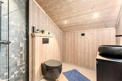 a bathroom with a toilet and a sink at Rindabakkane Lodge in Sogndal
