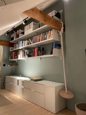 a room with a book shelf with books at Tomannsbolig på Rosenborg in Trondheim