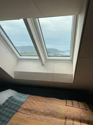 a bedroom with a window and a bed in front of it at Tomannsbolig på Rosenborg in Trondheim