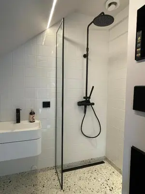 a shower with a glass door in a bathroom at Tomannsbolig på Rosenborg in Trondheim