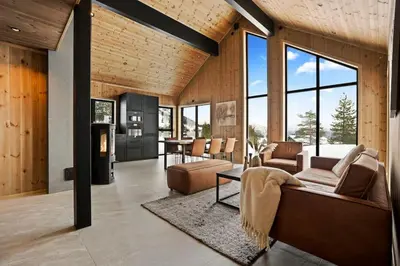 a living room with a couch and a table at Tonningssætra Mountain Lodge in Stryn