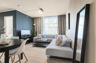 a living room with a couch and a table at Family Friendly - Modern - City Central in Bergen