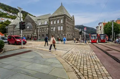a group of people crossing a street in front of a building at Family Friendly - Modern - City Central in Bergen