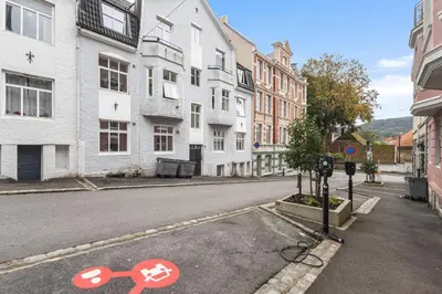 an empty street with two crossed signs on the road at Family Friendly - Modern - City Central in Bergen