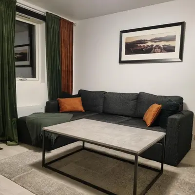 a living room with a couch and a coffee table at Apartment near center / free P in Ålesund