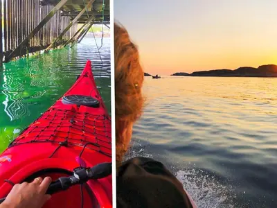 a dog and a red kayak in the water at 8 person holiday home in averøy-By Traum in Averoy