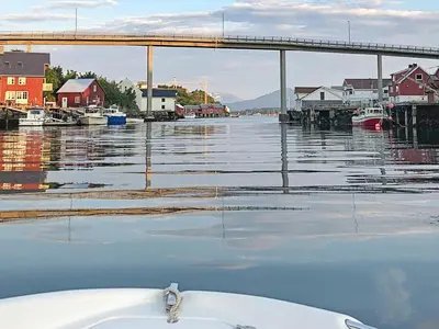 a boat in a body of water with a bridge at 8 person holiday home in averøy-By Traum in Averoy