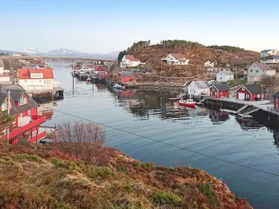 a river with houses and boats in a town at 8 person holiday home in averøy-By Traum in Averoy