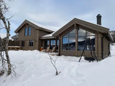 a house in the snow in front at Hjemmekoselig hytte på Rauland in Rauland