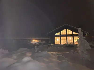 a house is covered in snow at night at Holiday home in beautiful Sjusjøen, near Lillehammer in Ringsaker