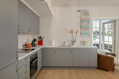a kitchen with white cabinets and a sink in it at Holiday home in beautiful Sjusjøen, near Lillehammer in Ringsaker