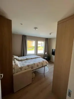 a bedroom with a bed and a window at Studio Leiligheit in Sogndal