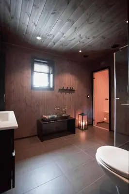 a bathroom with a room with a tub and a window at Luxurious 5-Bedroom Mountain Chalet with Sauna, Panoramic Views, and Two Full Bathrooms in Stranda