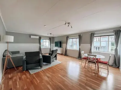 a living room with a couch and chairs and a table at Trolltunga Sleep in Tveit