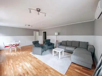 a living room with a couch and a table at Trolltunga Sleep in Tveit