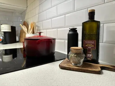 a bottle of wine sitting on a counter next to a mortar and pestle at Apartments Bergen with sea view! in Bergen