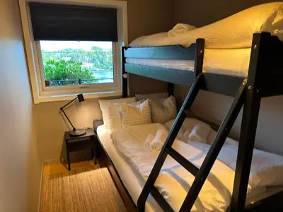 a room with two bunk beds and a window at Apartments Bergen with sea view! in Bergen