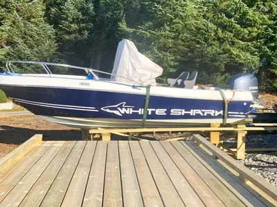 a blue and white boat sitting on a wooden deck at 6 person holiday home in Ånneland-By Traum in Ånneland