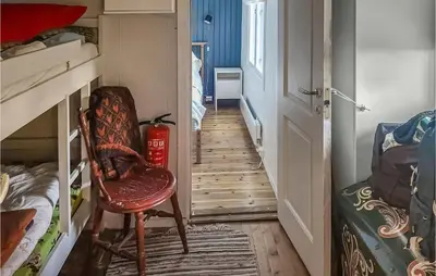a hallway with a chair in a room with bunk beds at 2 Bedroom Awesome Home In Lillehammer in Lillehammer