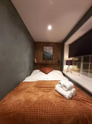 a bedroom with a large bed with towels on it at Fossheim Lodge Nr 10 in Torset