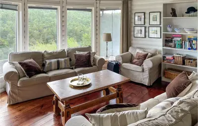 a living room with couches and a coffee table at Beach Front Home In Førde I Hordaland in Erve