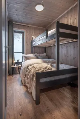 a bedroom with two bunk beds in a log cabin at Exclusive Nordic Apartment with Sauna - Prime Location at Stranda near Geiranger in Stranda