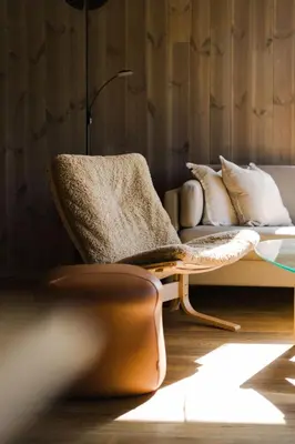 a living room with a couch and a lamp at Exclusive Nordic Apartment with Sauna - Prime Location at Stranda near Geiranger in Stranda