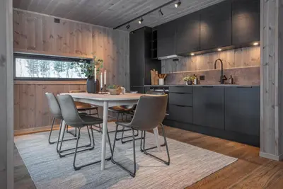 a kitchen with a white table and chairs at Exclusive Nordic Apartment with Sauna - Prime Location at Stranda near Geiranger in Stranda