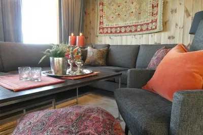 a living room with a couch and a table with candles at Bualie - Golsfjellet - Biking, swimmming, hiking. High standard. in Gol