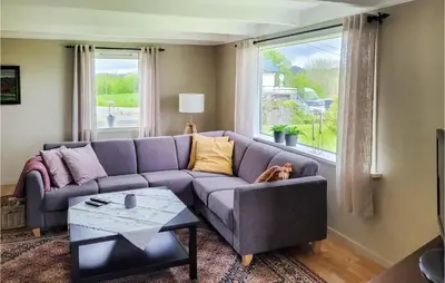 a living room with a purple couch and a window at Beautiful Home In Sveio With Wifi in Sveio