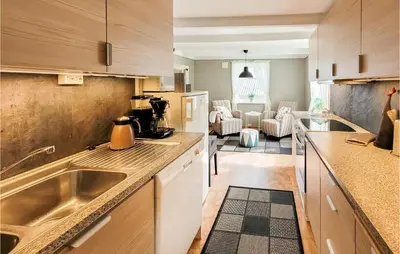a kitchen with a sink and a counter top at Beautiful Home In Sveio With Wifi in Sveio