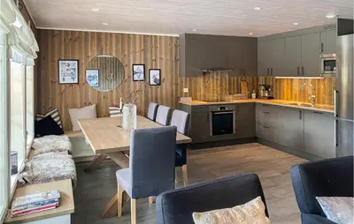 a kitchen and dining room with a table and chairs at Amazing Home In Nordfjordeid With Wifi in Nordfjordeid