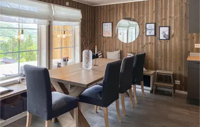 a dining room with a wooden table and chairs at Amazing Home In Nordfjordeid With Wifi in Nordfjordeid