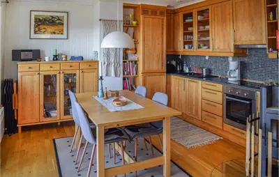 a kitchen with wooden cabinets and a wooden table at Awesome Apartment In Rauland With Sauna in Rauland