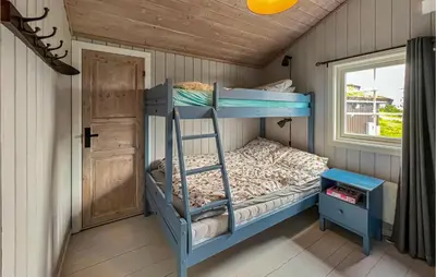 a bunk bed in a room with a window at 3 Bedroom Amazing Home In Lillehammer in Lillehammer