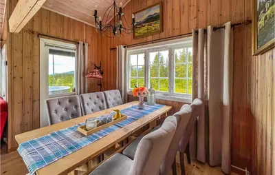 a dining room with a wooden table and chairs at 3 Bedroom Amazing Home In Lillehammer in Lillehammer