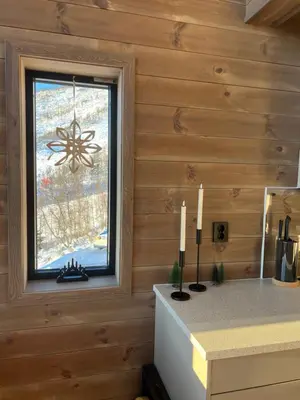 a kitchen with a window and candles on a counter at Rindabotten Panorama in Sogndal