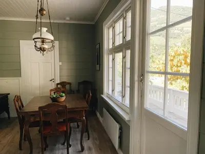 a dining room with a table and a window at Valldal Sentrum Overnatting in Valldal